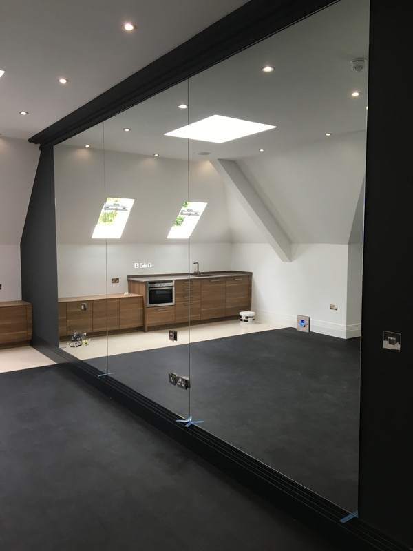 Frameless glass partition in loft conversion by Chiswick glaziers